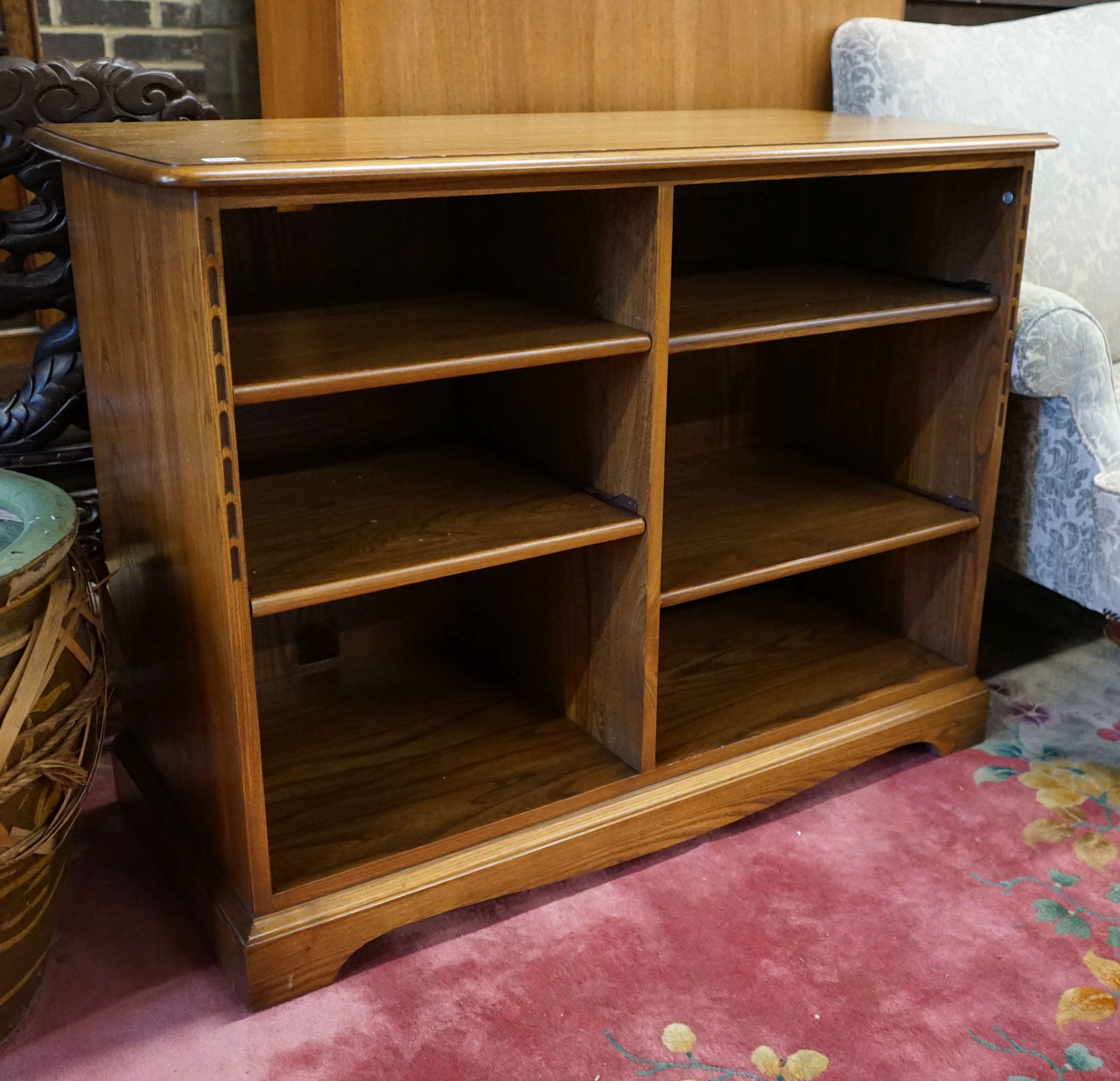 An Ercol elm open media unit, width 110cm, depth 52cm, height 82cm